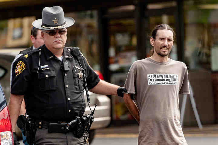 A traffic stop at the Duke and Duchess Station on Coshocton Avenue Friday resulted in the arrest of Brian Rose by the Knox County Sheriff’s Office. Deputy Wayne Noggle escorts Rose to a cruiser. Rose was booked into the Knox County Jail under a charge of aggravated possession of drugs.  (Joshua Morrison / Mount Vernon News)